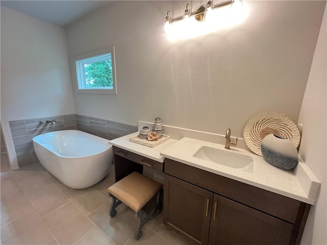1005 Liberty Springs Dr, Woodstock, GA 30188 - bathroom featuring a soaking tub, vanity, tile patterned flooring, and tile walls