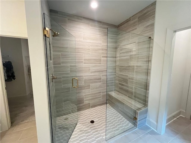 1005 Liberty Springs Dr, Woodstock, GA 30188 - bathroom featuring tile patterned floors, a shower stall, a spacious closet, and recessed lighting