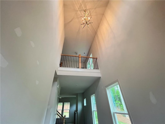 1005 Liberty Springs Dr, Woodstock, GA 30188 - staircase with a high ceiling and a chandelier