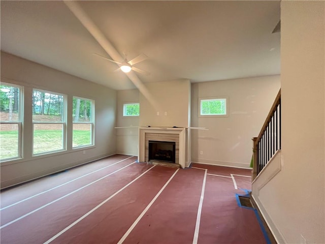 1005 Liberty Springs Dr, Woodstock, GA 30188 - unfurnished living room featuring a ceiling fan and a fireplace with flush hearth