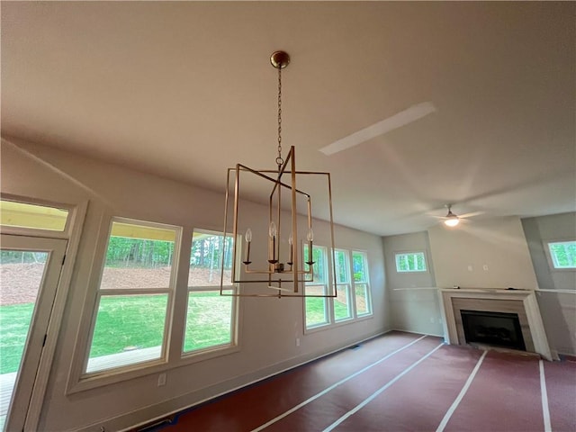 1005 Liberty Springs Dr, Woodstock, GA 30188 - unfurnished living room with healthy amount of natural light, a ceiling fan, a fireplace, and a chandelier