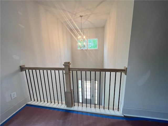 1005 Liberty Springs Dr, Woodstock, GA 30188 - stairs featuring a chandelier and wood finished floors