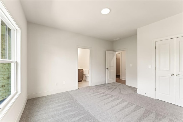1005 Liberty Springs Dr, Woodstock, GA 30188 - unfurnished bedroom featuring light carpet, a closet, and connected bathroom