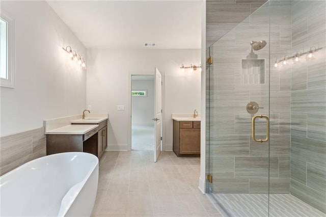 1005 Liberty Springs Dr, Woodstock, GA 30188 - full bath featuring vanity, a freestanding bath, a stall shower, and tile patterned floors
