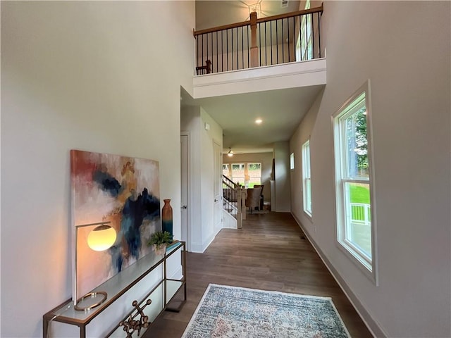 1005 Liberty Springs Dr, Woodstock, GA 30188 - hallway with stairs, a towering ceiling, and dark wood-type flooring
