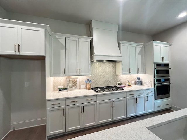 1005 Liberty Springs Dr, Woodstock, GA 30188 - kitchen with premium range hood, dark wood-style flooring, backsplash, and stainless steel appliances