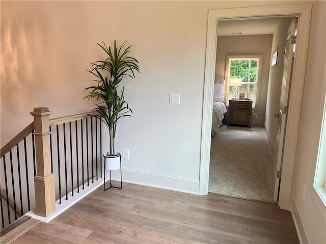 1005 Liberty Springs Dr, Woodstock, GA 30188 - hall with wood finished floors and an upstairs landing