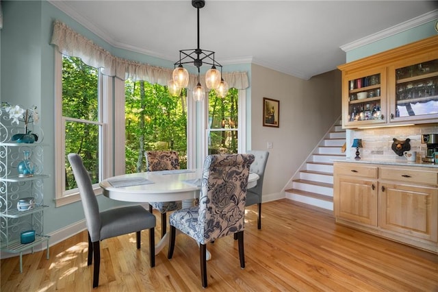 711 Wildcat Dr, Big Canoe, GA 30143 - dining room with baseboards, light wood finished floors, crown molding, and stairs
