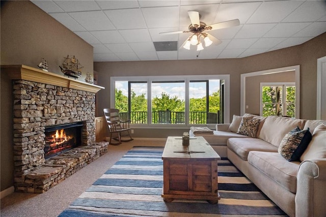 711 Wildcat Dr, Big Canoe, GA 30143 - living area featuring plenty of natural light, carpet, a fireplace, ceiling fan, and a paneled ceiling