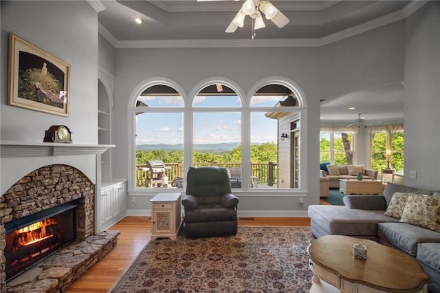 711 Wildcat Dr, Big Canoe, GA 30143 - living area with ceiling fan, light wood-style floors, a fireplace, ornamental molding, and baseboards