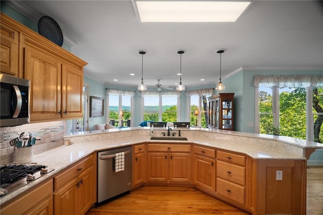 711 Wildcat Dr, Big Canoe, GA 30143 - kitchen with appliances with stainless steel finishes, a sink, ornamental molding, light wood-style flooring, and tasteful backsplash