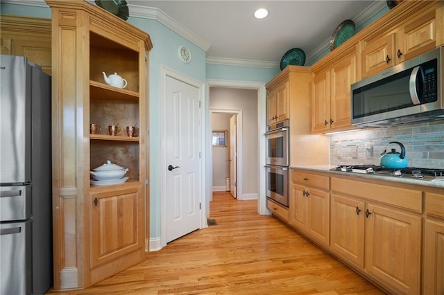 711 Wildcat Dr, Big Canoe, GA 30143 - kitchen with stainless steel appliances, tasteful backsplash, light countertops, light wood-style floors, and crown molding