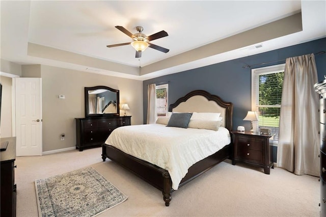 2740 Greymont Ct, Cumming, GA 30041 - bedroom featuring a raised ceiling, light colored carpet, and ceiling fan