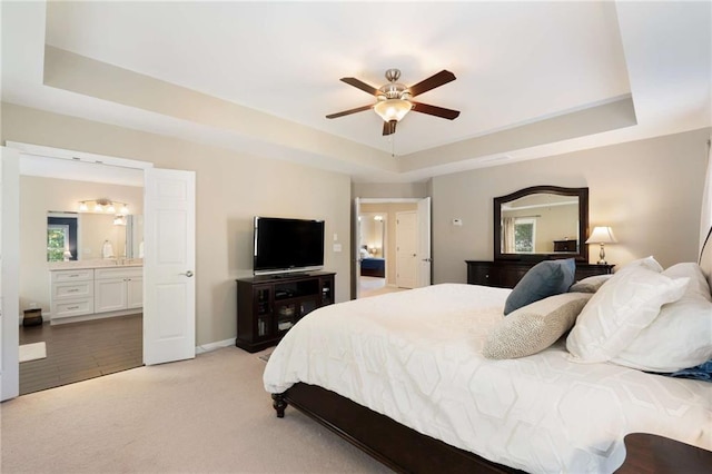 2740 Greymont Ct, Cumming, GA 30041 - bedroom featuring a raised ceiling, light colored carpet, ensuite bathroom, and ceiling fan