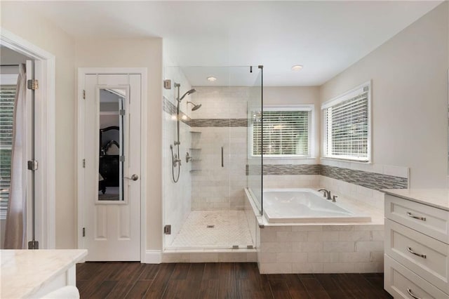 2740 Greymont Ct, Cumming, GA 30041 - full bathroom with a garden tub, wood finished floors, a stall shower, vanity, and recessed lighting