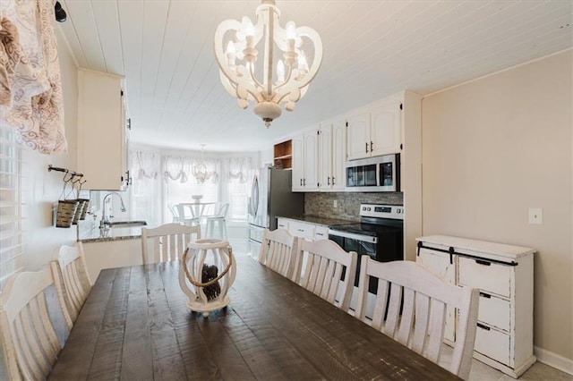 511 Laird Rd, Hiram, GA 30141 - dining room featuring a chandelier, wooden ceiling, and baseboards