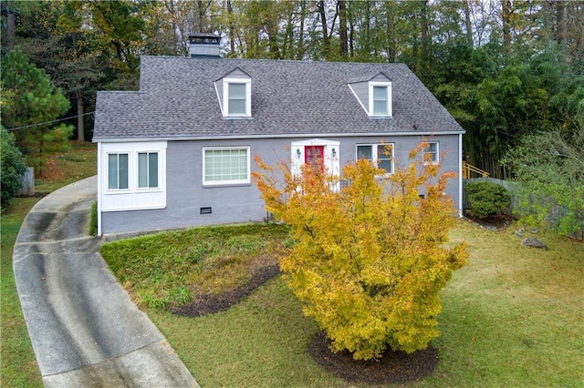 view of property exterior featuring a yard, brick siding, roof with shingles, and a chimney