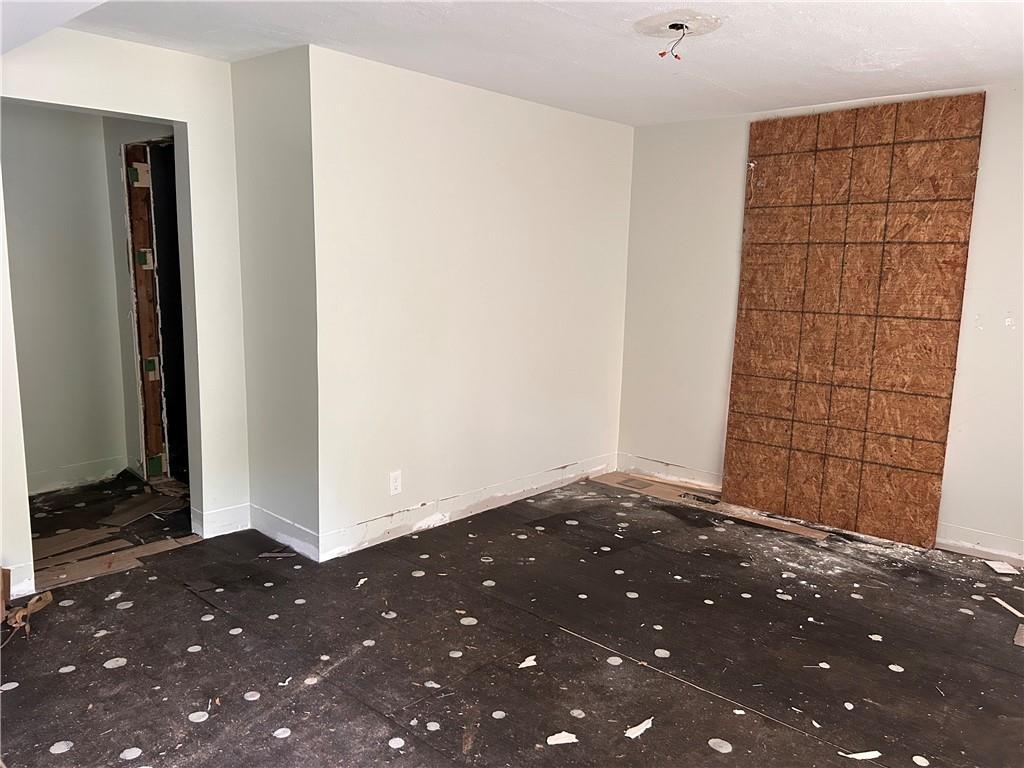 spare room featuring baseboards