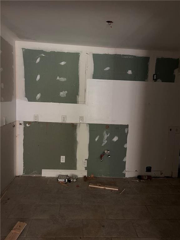 clothes washing area featuring tile patterned floors
