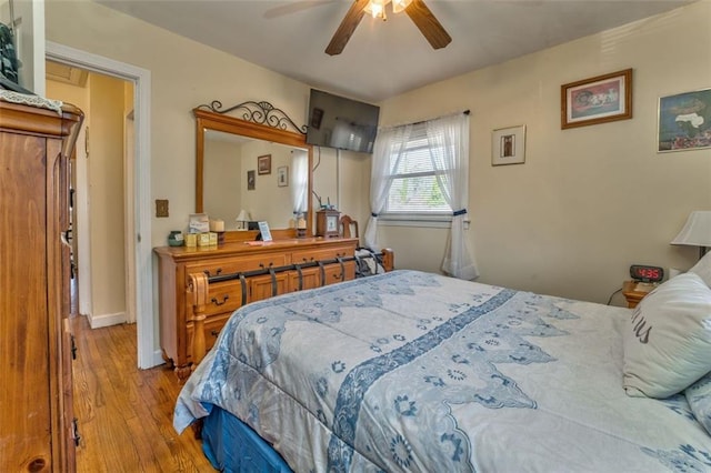 bedroom with baseboards and wood finished floors