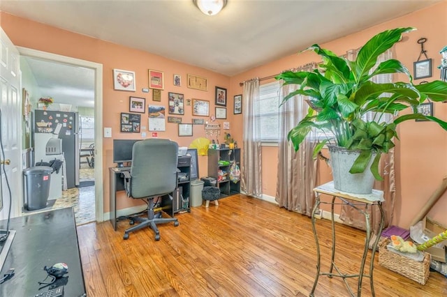 office space with baseboards and wood finished floors