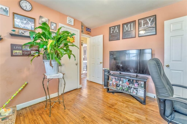 office space with baseboards and wood finished floors