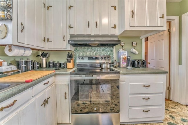 kitchen with stainless steel electric stove, tasteful backsplash, light countertops, white cabinetry, and under cabinet range hood