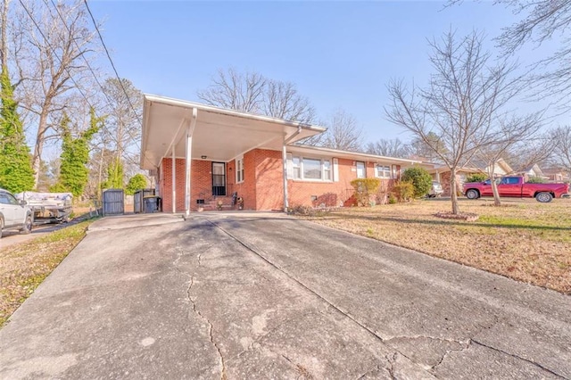 view of front facade with driveway, crawl space, and brick siding