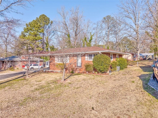 single story home with brick siding and a front lawn