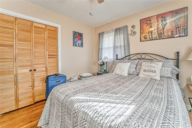 bedroom with a ceiling fan, a closet, and wood finished floors