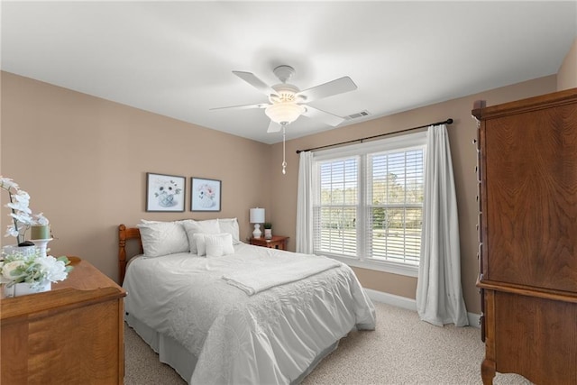 bedroom featuring light carpet and ceiling fan