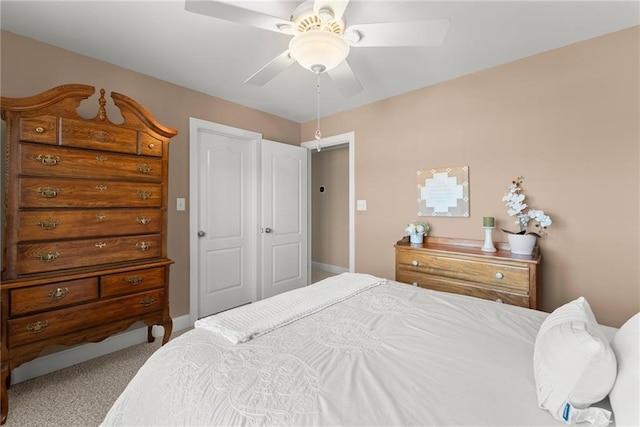 bedroom with ceiling fan, carpet flooring, and a closet