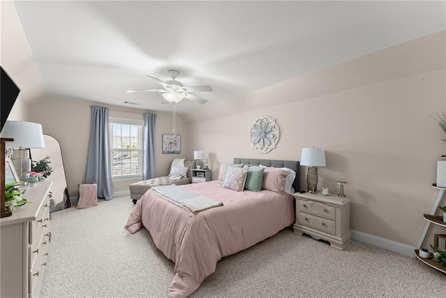 bedroom featuring vaulted ceiling, light colored carpet, and ceiling fan