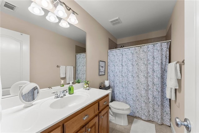 bathroom with vanity, tile patterned floors, and toilet