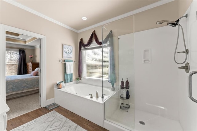 bathroom featuring wood-type flooring, crown molding, and plus walk in shower