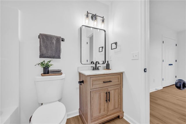 bathroom featuring hardwood / wood-style flooring, vanity, and toilet