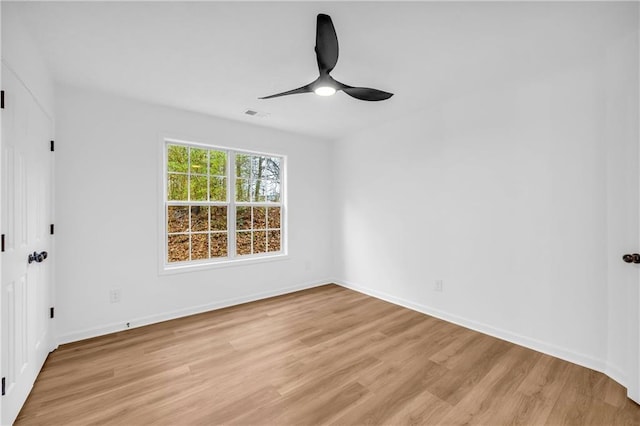 empty room featuring ceiling fan and light wood-type flooring