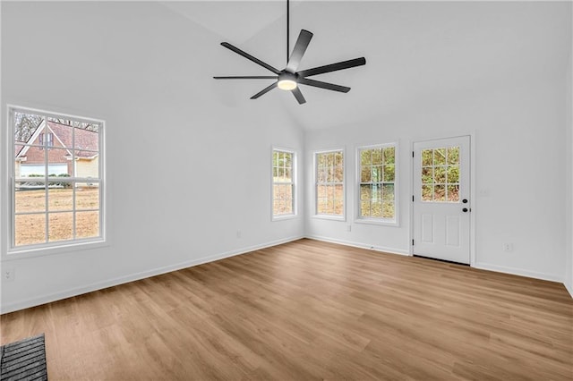 interior space with ceiling fan, high vaulted ceiling, a healthy amount of sunlight, and light hardwood / wood-style floors