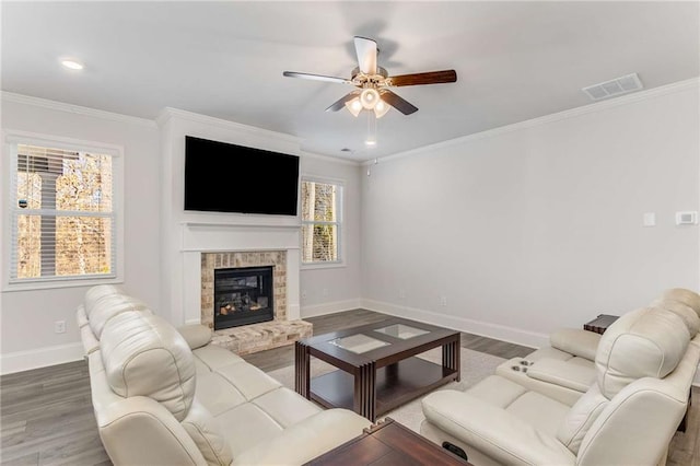 living room with ceiling fan, wood-type flooring, and ornamental molding