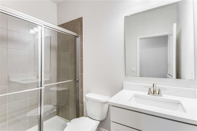 bathroom with walk in shower, vanity, and toilet