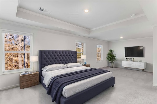 bedroom featuring a raised ceiling, ornamental molding, and light carpet