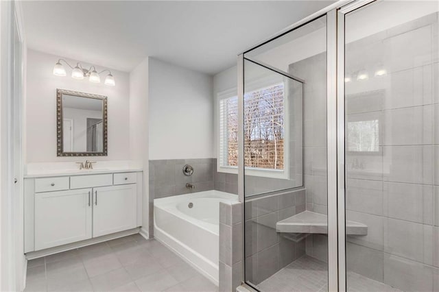 bathroom featuring vanity, tile patterned floors, and separate shower and tub