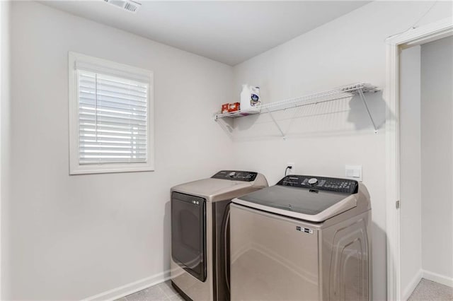 laundry room featuring washer and dryer and light tile patterned flooring