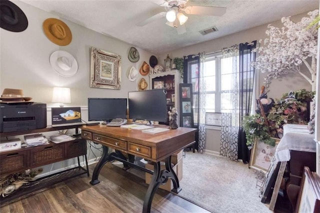 office area with a textured ceiling, ceiling fan, and hardwood / wood-style floors