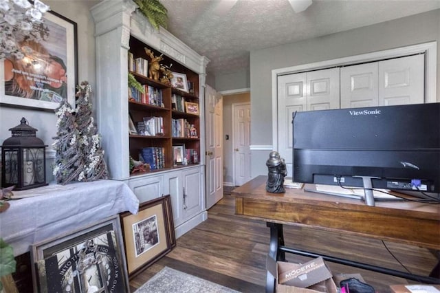 office space with a textured ceiling, ceiling fan, and dark hardwood / wood-style floors