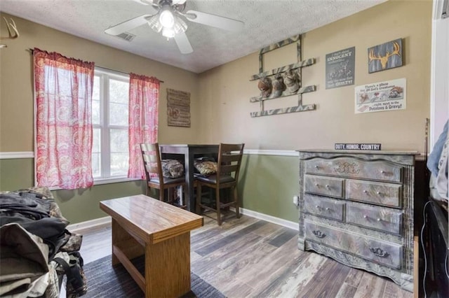 office space featuring a textured ceiling, ceiling fan, and wood-type flooring