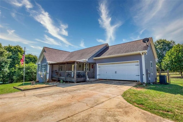 single story home featuring a garage, covered porch, and a front yard