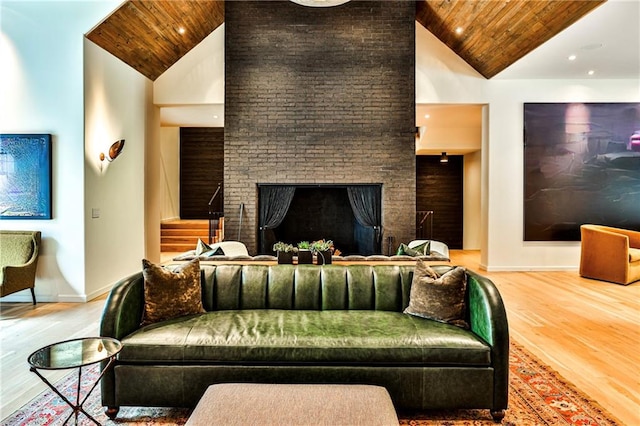 living room with a brick fireplace, high vaulted ceiling, wooden ceiling, and hardwood / wood-style flooring