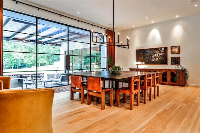 dining space featuring a chandelier and light wood-type flooring