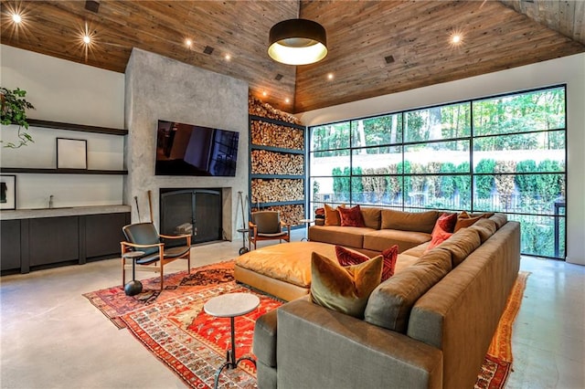 living room with a wealth of natural light, a fireplace, high vaulted ceiling, and wood ceiling